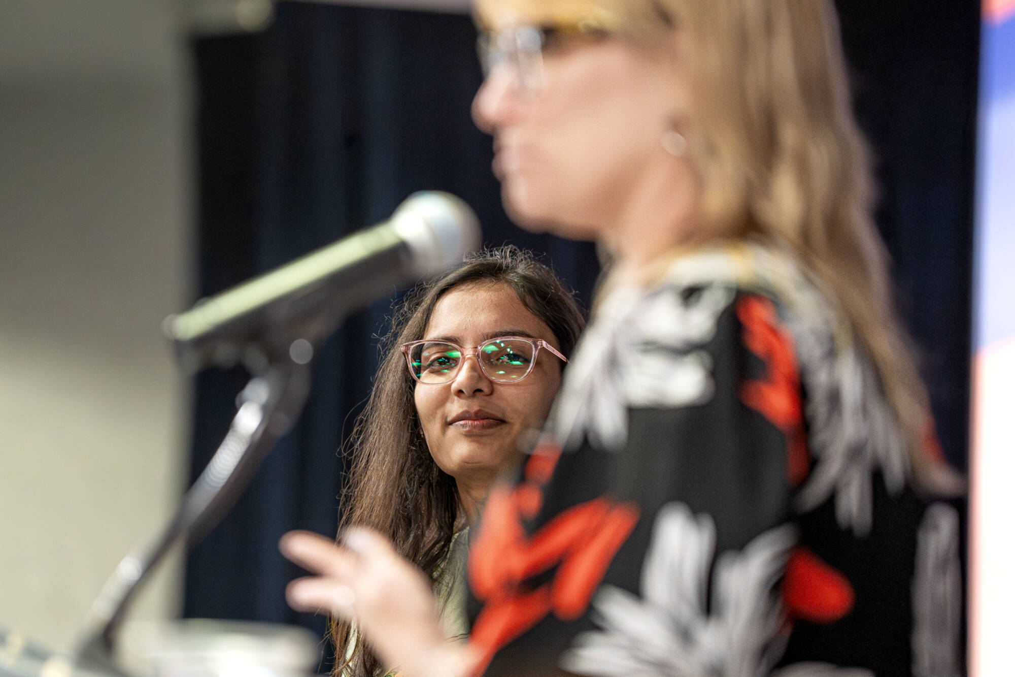 A GVSU student smiling after being recognized for being an outstanding student at the Women's Award event.
